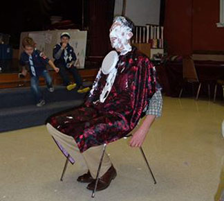Dr. Grambau with a pie in his face
